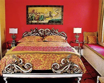 a bedroom with a bed with red walls at Millbrook Country House in Millbrook