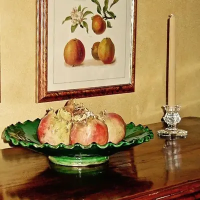 a plate of fruit on a table with a picture of pears at Millbrook Country House in Millbrook