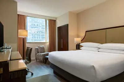 a hotel room with a large bed and a window at Sheraton Brooklyn New York in Brooklyn
