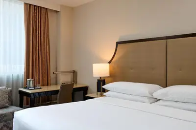 a hotel room with a bed and a desk at Sheraton Brooklyn New York in Brooklyn