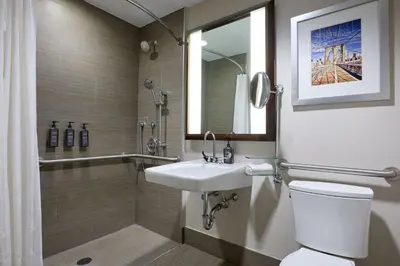 a bathroom with a toilet and a sink and a shower at Sheraton Brooklyn New York in Brooklyn
