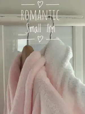a person wrapped in a pink towel next to a window at The Country Inn in Stone Ridge