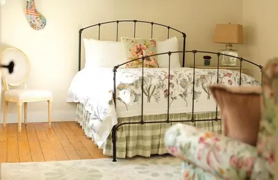 a bedroom with a bed and a chair at The Country Inn in Stone Ridge