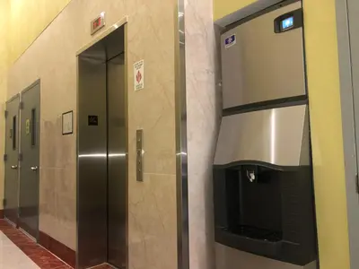 a row of elevators in a bathroom at Elmhurst Hotel in Queens