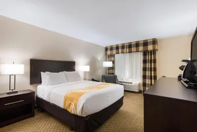 a hotel room with a bed and a television at Quality Inn Oneonta Cooperstown Area in Oneonta