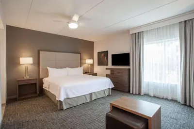 a hotel room with a bed and a television at Homewood Suites By Hilton Saratoga Springs in Saratoga Springs