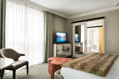 a hotel room with a bed and a television at Delamar West Hartford in West Hartford