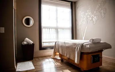 a bedroom with a bed in front of a window at Delamar West Hartford in West Hartford
