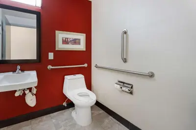 a bathroom with a toilet and a sink at Comfort Inn & Suites near Stadium in Bronx