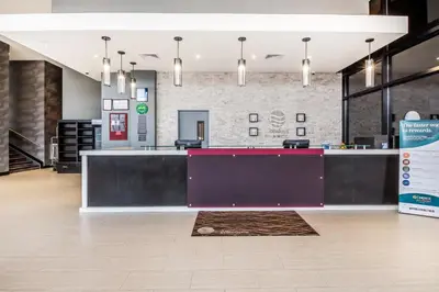 a lobby with a purple counter in a building at Comfort Inn & Suites near Stadium in Bronx