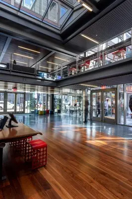a large room with a wooden floor and a table at Pod Brooklyn in Brooklyn