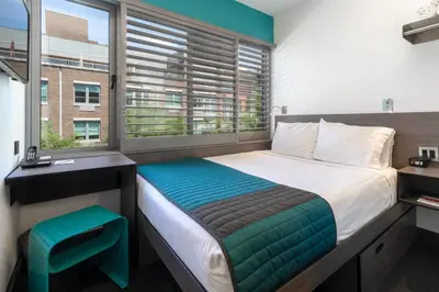 a bedroom with a large bed and a window at Pod Brooklyn in Brooklyn