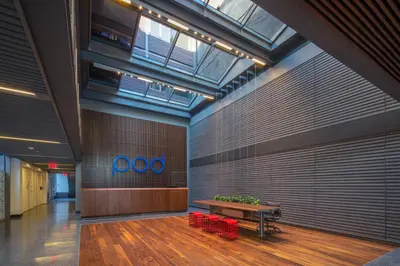 a lobby with a table and a bench in a room at Pod Brooklyn in Brooklyn