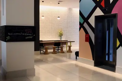 a dining room with a table and a wall at Pod Times Square in New York