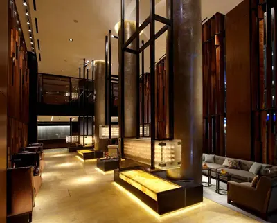 a lobby with a couch and a fireplace at The Dominick Hotel in New York