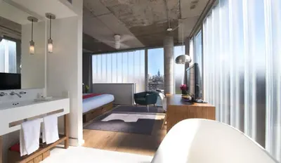a hotel room with a bed and a bathroom at Nolitan Hotel SoHo - New York in New York