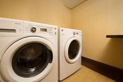 a white washer and dryer in a laundry room at Fairfield Inn & Suites by Marriott Albany East Greenbush in East Greenbush