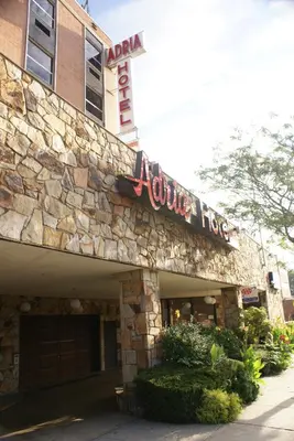 a stone building with a sign that reads your house at Adria Hotel and Conference Center in Queens