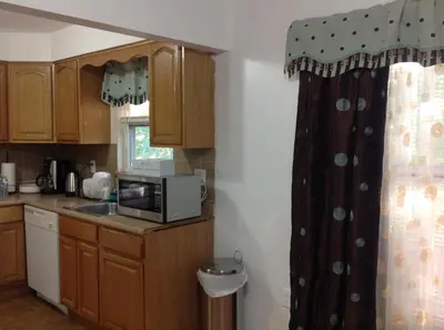 a kitchen with a sink and a microwave at Mojoy Homesuites At Runyon in Newark