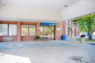 a brick building with a glass door on a street at Motel 6-Albany, NY in Albany