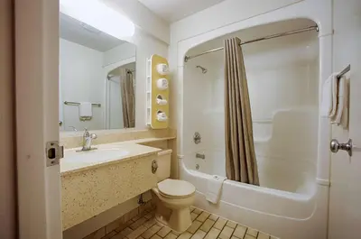 a bathroom with a toilet and a sink and a shower at Motel 6-Albany, NY in Albany