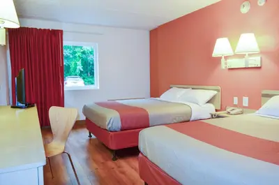 a hotel room with two beds and a television at Motel 6-Albany, NY in Albany