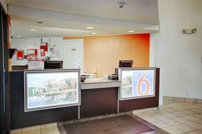 a restaurant with a counter with a light on for you at Motel 6-Albany, NY in Albany