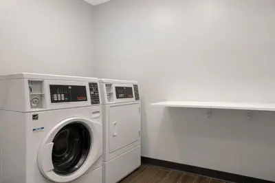 a washer and dryer in a room with a counter at Spark by Hilton West Coxsackie in West Coxsackie