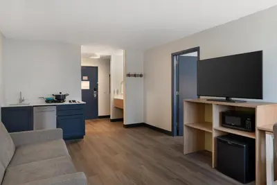 a living room with a couch and a flat screen tv at Spark by Hilton West Coxsackie in West Coxsackie