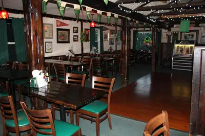 a dining room with wooden tables and chairs at Jimmy OConnor's Windham Mtn Inn in Windham
