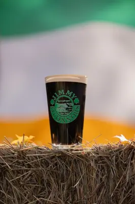 a glass of beer sitting on top of a pile of hay at Jimmy OConnor's Windham Mtn Inn in Windham