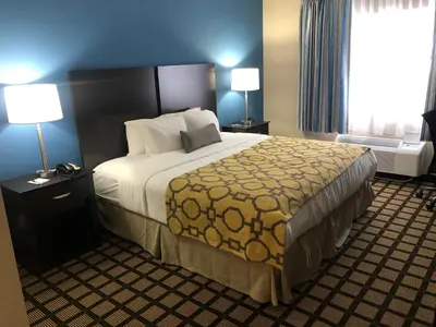 a hotel room with a large bed and a window at Baymont by Wyndham Latham Albany Airport in Latham
