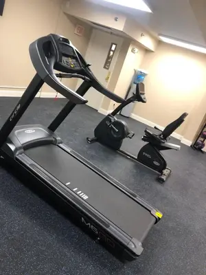 a treadmill and an exercise bike in a room at Baymont by Wyndham Latham Albany Airport in Latham