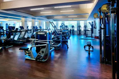 a gym with lots of treadmills and cardio machines at New York Marriott Downtown in New York