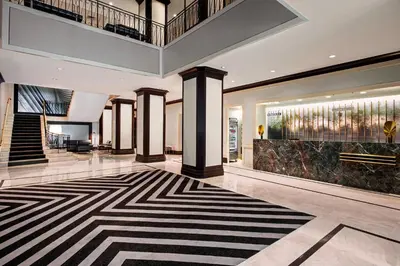 a lobby with a staircase and a lobby with a rug at New York Marriott Downtown in New York