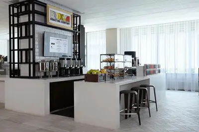 a bar in a room with stools and a counter at New York Marriott at the Brooklyn Bridge in Brooklyn