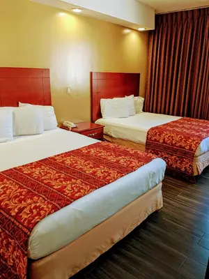 a hotel room with two beds in a room at Jets Motor Inn in Queens