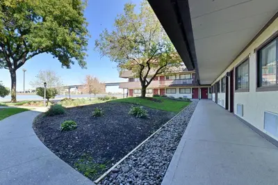 a building with a sidewalk next to a building at Red Roof Inn PLUS+ Secaucus - Meadowlands in Secaucus