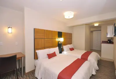 a hotel room with two beds and a desk at Hotel Five44 in New York