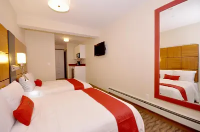 a hotel room with two beds and a large mirror at Hotel Five44 in New York