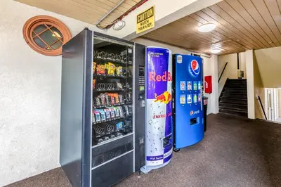 a vending machine in a building with two soda machines at Red Carpet Inn - Stamford in Stamford