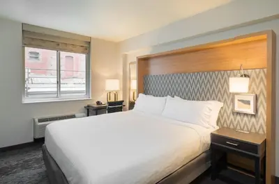 a hotel room with a large bed and a window at Holiday Inn New York City - Wall Street by IHG in New York