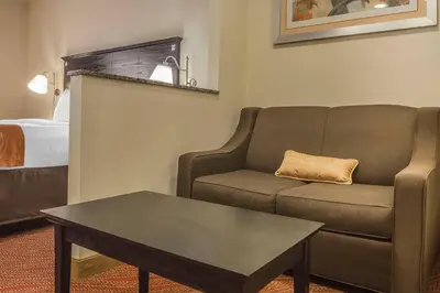 a living room with a couch and a coffee table at Comfort Inn & Suites LaGuardia Airport in Queens