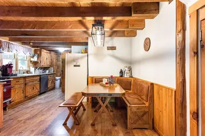 a kitchen with a table and a refrigerator at Roscoe Retreat in Roscoe