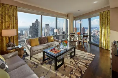 a living room with a couch and a table at Mandarin Oriental, New York in New York