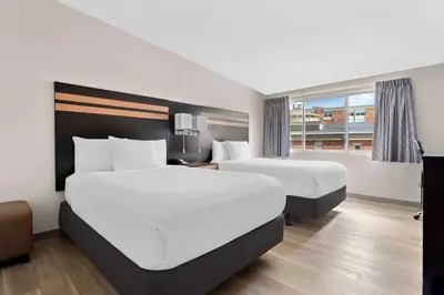 a hotel room with two beds and a window at Days Inn by Wyndham Albany SUNY in Albany
