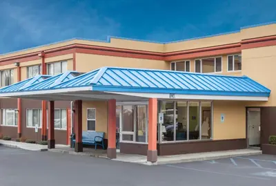 a building with a blue roof at Days Inn by Wyndham Albany SUNY in Albany