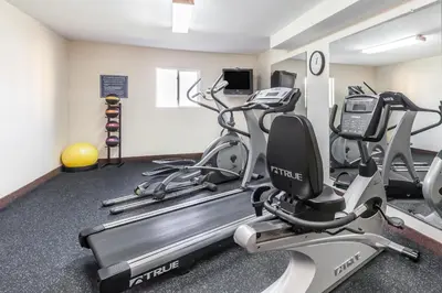 a gym with two cardio bikes in a room at Days Inn by Wyndham Albany SUNY in Albany