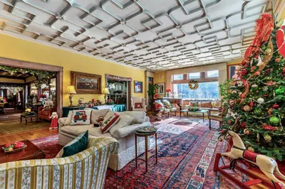 a living room with a christmas tree in it at Wilburton Inn in Manchester