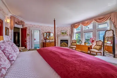 a large bedroom with a large bed with a red blanket at Wilburton Inn in Manchester